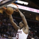 Cleveland Cavaliers' Tristan Thompson (13) dunks in front of Toronto Raptors' Jonas Valanciunas (17) during the second quarter of an NBA basketball game Wednesday, Feb. 27, 2013, in Cleveland. (AP Photo/Tony Dejak)