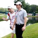 Rory McIlroy of Northern Ireland (R), talks with his caddie JP Fitzgerald (L), as they walk to the seventh green during the second round of the Tour Championship golf tournament at the East Lake Golf Club in Atlanta, Georgia, September 21, 2012. REUTERS/Tami Chappell