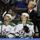 Dallas Stars' head coach Lindy Ruff looks at the scoreboard for a video tribute about his career in Buffalo during the first period of an NHL hockey game against the Buffalo Sabres in Buffalo, N.Y., Monday, Oct. 28, 2013. (AP Photo/Gary Wiepert)