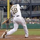 Pittsburgh Pirates' Neil Walker (18) swings on a pitch by Arizona Diamondbacks' Ian Kennedy and hits it for a three-run home run in the first inning of the baseball game Wednesday, Aug. 8, 2012, in Pittsburgh. (AP Photo/Keith Srakocic)