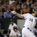 Chicago White Sox designated hitter Adam Dunn hits a two-run home run off Minnesota Twins relief pitcher Tyler Robertson, also scoring Kevin Youkilis, during the seventh inning of a baseball game, Tuesday, July 24, 2012 in Chicago. (AP Photo/Charles Rex Arbogast)