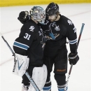 San Jose Sharks goalie Antti Niemi (31), of Finland, is congratulated by teammate defenseman Brad Stuart (7) after a 2-1 victory against the Los Angeles Kings in Game 6 of their second-round NHL hockey Stanley Cup playoff series in San Jose, Calif., Sunday, May 26, 2013. (AP Photo/Tony Avelar)