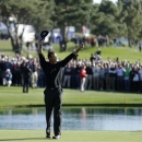 Tiger Woods celebrates after his victory in the Farmers Insurance Open golf tournament Monday, Jan. 28, 2013, at Torrey Pines Golf course in San Diego. (AP Photo/Gregory Bull)