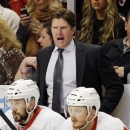 Detroit Red Wings head coach Mike Babcock, top, yells to his team during the first period of Game 5 of the NHL hockey Stanley Cup playoffs Western Conference semifinals against the Chicago Blackhawks in Chicago, Saturday, May 25, 2013. (AP Photo/Nam Y. Huh)