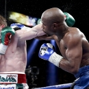 Floyd Mayweather Jr. lands a punch against Canelo Alvarez in the ninth round during a 152-pound title fight, Saturday, Sept. 14, 2013, in Las Vegas. (AP Photo/Eric Jamison)