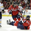 Washington Capitals right wing Joel Ward (42) celebrates his goal with teammate Mike Green (52) as Buffalo Sabres defenseman Jordan Leopold (3) looks on during the first period of an NHL hockey game on Sunday, Jan. 27, 2013, in Washington. (AP Photo/Nick Wass)
