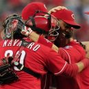 Cincinnati Reds players mob relief pitcher Aroldis Chapman, center, after they defeated the Los Angeles Dodgers 6-0 to clinch the National League Central Division in a baseball game on Saturday, Sept. 22, 2012, in Cincinnati. (AP Photo/Al Behrman)