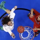 Baylor's Brittney Griner (42) and Louisville forward Monique Reid (33) reach for a rebound in the first half of a regional semifinal in the women's NCAA college basketball tournament in Oklahoma City, Sunday, March 31, 2013. Louisville won 82-81. (AP Photo/Sue Ogrocki)