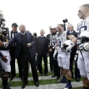 Sen. John McCain, R-Ariz., center, shakes hands with Navy and Arizona State players before the start of the Fight Hunger Bowl NCAA college football game in San Francisco, Saturday, Dec. 29, 2012. (AP Photo/Marcio Jose Sanchez)