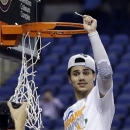 Miami's Shane Larkin (0) celebrates after an NCAA college basketball game against North Carolina in the championship of the Atlantic Coast Conference tournament in Greensboro, N.C., Sunday, March 17, 2013. Miami won 87-77. (AP Photo/Gerry Broome)