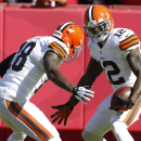 Cleveland Browns wide receiver Josh Gordon (12) celebrates his touchdown with teammate Greg Little (18) during the first half of an NFL football game against the Kansas City Chiefs in Kansas City, Mo., Sunday, Oct. 27, 2013. (AP Photo/Colin E. Braley)