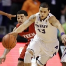 Kansas State guard Angel Rodriguez (13) is covered by Texas Tech guard Josh Gray during the first half of an NCAA college basketball game in Manhattan, Kan., Monday, Feb. 25, 2013. (AP Photo/Orlin Wagner)