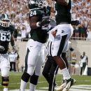 Michigan State's Le'Veon Bell (24) and Bennie Fowler (13) celebrate Bell's first-quarter touchdown against Boise State in an NCAA college football game, Friday, Aug. 31, 2012, in East Lansing, Mich. (AP Photo/Al Goldis)