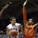 Duke's Seth Curry drives between Virginia Tech's Robert Brown, left, and Jarell Eddie during the first half of an NCAA college basketball game in Durham, N.C., Tuesday, March 5, 2013. (AP Photo/Gerry Broome)