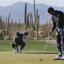 Belgium's Nicolas Colsaerts, left, places his ball on the fourth green as Matt Kuchar lines up his putt during a third round match at the Match Play Championship golf tournament, Saturday, Feb. 23, 2013, in Marana, Ariz. (AP Photo/Julie Jacobson)