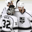 Los Angeles Kings center Jeff Carter (77) celebrate the Kings' 6-2 win over the Chicago Blackhawks with goalie Jonathan Quick (32) after Game 2 of the Western Conference finals in the NHL hockey Stanley Cup playoffs Wednesday, May 21, 2014, in Chicago. (AP Photo/Charles Rex Arbogast)