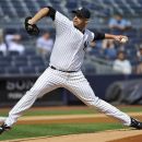 New York Yankees starter Andy Pettitte delivers a pitch to the Toronto Blue Jays during the first inning of the first baseball game of a doubleheader, Wednesday, Sept. 19, 2012, at Yankee Stadium in New York. (AP Photo/Bill Kostroun)