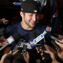 New England Patriots quarterback Tim Tebow speaks to media in the locker room after team football practice in Foxborough, Mass., Monday, Aug. 26, 2013. (AP Photo/Elise Amendola)