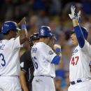 Los Angeles Dodgers' Luis Cruz, right, is congratulated by Hanley Ramirez, left, and Andre Ethier after hitting a three-run home run during the sixth inning of their baseball game against the St. Louis Cardinals, Friday, Sept. 14, 2012, in Los Angeles.  (AP Photo/Mark J. Terrill)