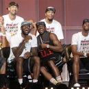 Miami Heat players laugh as they watch highlights of center Chris Bosh, right, Monday, June 24, 2013, during a celebration for season ticket holders at the American Airlines Arena in Miami. Other players from left are: Shane Battier, Juwan Howard, LeBron James, Dwyane Wade and Rashard Lewis. The Heat defeated the San Antonio Spurs 95-88 in Game 7 to win their second straight NBA championship. (AP Photo/Wilfredo Lee)