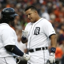 Detroit Tigers' Miguel Cabrera, right, after scoring on a solo home run in the first inning, points to Prince Fielder during a baseball game against the Philadelphia Phillies in Detroit, Saturday, July 27, 2013. (AP Photo/Carlos Osorio)