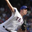 Texas Rangers starting pitcher Roy Oswalt (44) throws during the first inning of a baseball game against the Minnesota Twins, Sunday, July 8, 2012, in Arlington, Texas. (AP Photo/LM Otero)