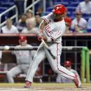 Philadelphia Phillies' Jimmy Rollins hits a solo home run during the first inning of a baseball game against the Miami Marlins, Tuesday, Aug. 14, 2012, in Miami. (AP Photo/Wilfredo Lee)