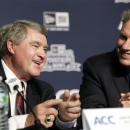 Atlantic Coast Conference Commissioner John Swofford, left, chats with New York Yankees baseball president Randy Levine during a news conference in which the Yankees and the college football Pinstripe Bowl announced a multi-year partnership with the ACC at Yankee Stadium, Tuesday, June 25, 2013, in New York. (AP Photo/Kathy Willens)