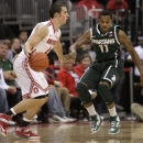 Ohio State's Aaron Craft, left, looks for an open pass as Michigan State's Keith Appling defends during the second half of an NCAA college basketball game Sunday, Feb. 24, 2013, in Columbus, Ohio. Ohio State beat Michigan State 68-60. (AP Photo/Jay LaPrete)