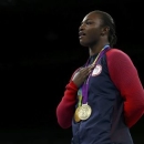 Rio Olympics - Boxing - Victory Ceremony - Women's Middle (75kg) Victory Ceremony - Riocentro - Pavilion 6 - Rio de Janeiro, Brazil - 21/08/2016. Gold medallist Claressa Shields (USA) of USA poses with her medals from London 2012 (purple) and Rio 2016 as she sings the national anthem.  REUTERS/Peter Cziborra