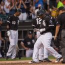 Chicago White Sox' Dayan Viciedo, foreground left, crosses home plate after hitting a two-run home run in the fourth inning of an interleague baseball game against the Milwaukee Brewers, Saturday, June 23, 2012 in Chicago. (AP Photo/Charles Cherney)