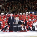 Chicago Blackhawks players pose with NHL deputy commissioner Bill Daly and the Western Conference Championship trophy as they win over Los Angeles Kings 4-3 in the second overtime period in Game 5 of the NHL hockey Stanley Cup playoffs Western Conference finals, Saturday, June 8, 2013, in Chicago. The Blackhawks advance to the Stanley Cup finals. (AP Photo/Nam Y. Huh)
