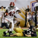 Alabama's Eddie Lacy (42) runs past Notre Dame's Danny Spond (13) during the first half of the BCS National Championship college football game Monday, Jan. 7, 2013, in Miami. (AP Photo/David J. Phillip)