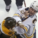 Buffalo Sabres left wing John Scott (32) follows through after landing a punch during a fight with Boston Bruins right wing Shawn Thornton, left, during the first period of an NHL hockey game in Boston, Thursday, Jan. 31, 2013. (AP Photo/Charles Krupa)