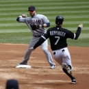 Cleveland Indians second baseman Jason Kipnis, left, turns the double play forcing Chicago White Sox's Jeff Keppinger at second and getting Alex Rios at first during the first inning of a baseball game Wednesday, April 24, 2013, in Chicago. (AP Photo/Charles Rex Arbogast)