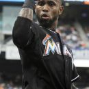 Miami Marlins' Jose Reyes flexes his muscles after teammate Giancarlo Stanton hit a two-run home run in the first inning of a baseball game against the New York Mets in New York, Wednesday, Aug. 8, 2012. (AP Photo/Henny Ray Abrams)