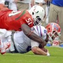 Miami's Shayon Green sacks Florida quarterback Jeff Driskel in the third quarter of an NCAA football game, Saturday, Sept. 7, 2013, in Miami Gardens, Fla. Miami won 21-16. (AP Photo/The Miami Herald, Charles Trainor Jr)