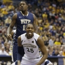 Marquette's Steve Taylor, Jr., (25) reacts in front of Pittsburgh's Dante Taylor (11) \during the first half of an NCAA college basketball game Saturday, Feb. 16, 2013, in Milwaukee. (AP Photo/Jeffrey Phelps)