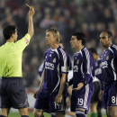 ** FILE ** Spanish referee Javier Turienzo Alvarez, left, shows a yellow card to Real Madrid's Jose Maria 'Guti' Gutierrez, second left, as teammates Jose Antonio Reyes, centre, and Emerson look on during a Spanish league soccer match against  Racing Santander at El Sardinero stadium in Santander, Spain, in this Saturday, April 14, 2007 file photo. The referee said Tuesday, April 17, 2007, that he will file a complaint to police after claiming to have received death threats following the match where he  awarded two second-half penalties that gave Santander the 2-1 victory. (AP Photo/Paul White)