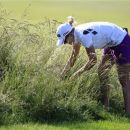 Pernilla Lindberg, of Sweden, looks for her ball in tall grass on the third hole during first round match in the LPGA ShopRite Classic golf competition at Stockton Seaview Hotel and Golf Club in Galloway, N.J., Friday, June 1, 2012. (AP Photo/Mel Evans)