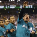 Seattle Mariners starting pitcher Felix Hernandez, right, and second baseman Robinson Cano, center, gesture fans from the dugout during the seventh inning of a baseball game against the Toronto Blue Jays, Monday, Aug. 11, 2014, in Seattle. The Mariners won 11-1. (AP Photo/Ted S. Warren)