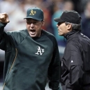 Oakland Athletics manager Bob Melvin, left, argues with umpire Angel Hernandez after a review failed to turn a double by Adam Rosales into a home run in the ninth inning of the A's baseball game against the Cleveland Indians on Wednesday, May 8, 2013, in Cleveland. Melvin was ejected. The Indians won 4-3. (AP Photo/Mark Duncan)
