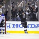 Los Angeles Kings right wing Justin Williams, right, celebrates his goal with defenseman Drew Doughty, center, as St. Louis Blues gather near the goal during the first period in Game 3 of an NHL hockey Stanley Cup second-round playoff series, Thursday, May 3, 2012, in Los Angeles. (AP Photo/Mark J. Terrill)