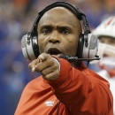FILE - In this Jan. 2, 2013, file photo, Louisville head coach Charlie Strong gestures as he talks with his players during the first half of the Sugar Bowl NCAA college football game against Florida in New Orleans. The Cardinals coach and the university agreed on an eight-year contract extension Wednesday, Jan. 23, 2013, that will pay him an annual base salary of $3.7 million, plus incentives worth at least $583,333 for reaching the BCS championship game. (AP Photo/Bill Haber, File)