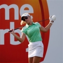 Natalie Gulbis of the United States stretches before teeing off on the 10th hole during the first round of the LPGA Malaysia golf tournament at Kuala Lumpur Golf and Country Club in Kuala Lumpur, Malaysia, Thursday, Oct. 11, 2012. (AP Photo/Lai Seng Sin)