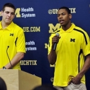 Michigan forward Mitch McGary, left, stands by as foward Glenn Robinson III speaks during an NCAA college basketball news conference, Thursday, April 18, 2013, in Ann Arbor, Mich. McGary and Robinson both announced they will forgo the NBA draft and instead return for their sophomore seasons. (AP Photo/Detroit News, John T. Greilick)
