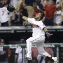 Cleveland Indians' Carlos Santana celebrates after rounding third base on his solo home run off Chicago White Sox relief pitcher Dylan Axelrod in the 10th inning of a baseball game, Wednesday, July 31, 2013, in Cleveland. The Indians won 6-5 in 10 innings. (AP Photo/Tony Dejak)