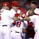 Los Angeles Angels' Torii Hunter, center, and teammates celebrate Hunter's RBI single during the ninth inning of a baseball game against the Seattle Mariners in Anaheim, Calif., Wednesday, Sept. 26, 2012. The Angels won 4-3. (AP Photo/Jae C. Hong)