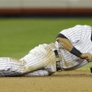 New York Yankees shortstop Derek Jeter reacts after injuring himself in the 12th inning of Game 1 of the American League championship series against the Detroit Tigers Sunday, Oct. 14, 2012, in New York. (AP Photo/Paul Sancya )