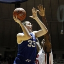Kentucky forward Kyle Wiltjer (33) scores on a shot past Mississippi forward Murphy Holloway (31) during the second half of their NCAA college basketball game, Tuesday, Jan. 29, 2013, in Oxford, Miss. Kentucky won 87-74. (AP Photo/Rogelio V. Solis)
